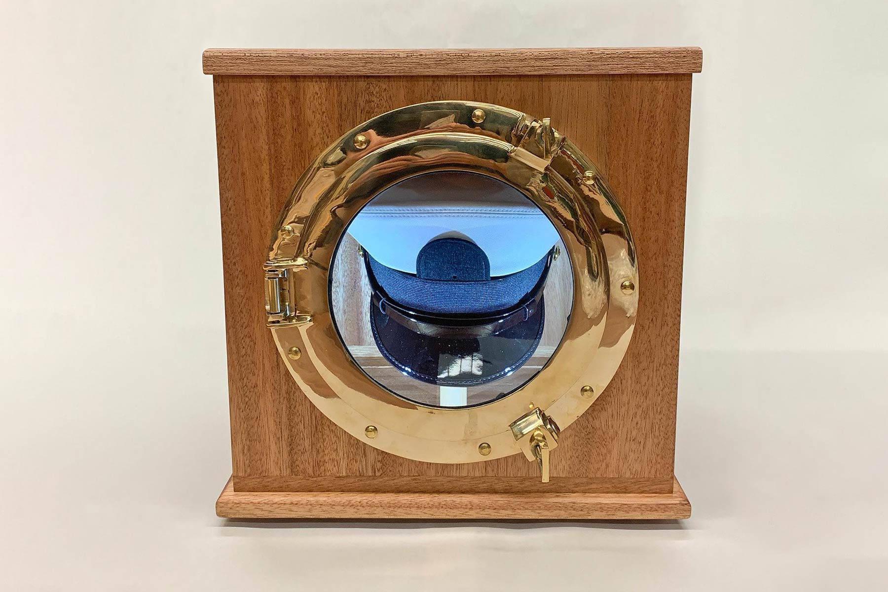 Front detail of Lit memorial box with CNC and brass porthole